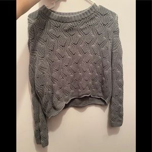 green cable-knit sweater